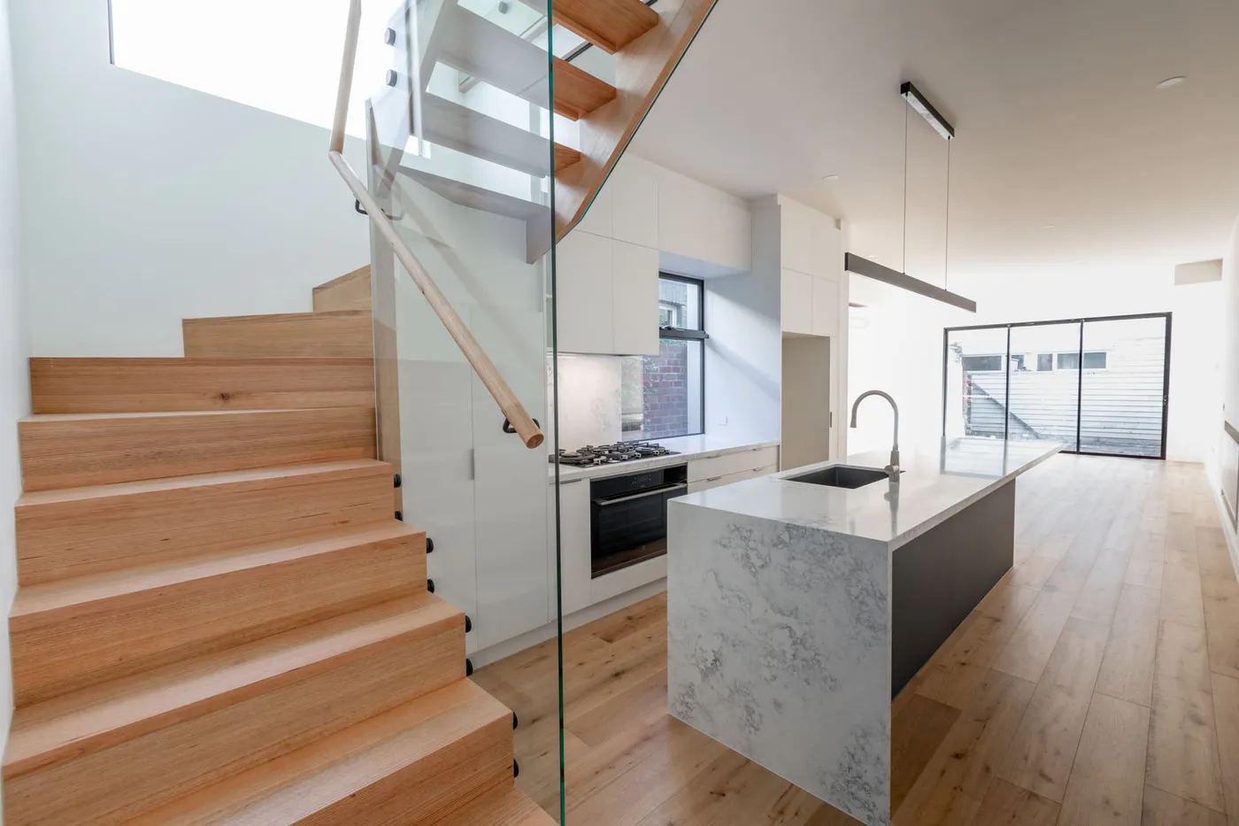 Timber staircase leading to renovated living space — Nicon Built