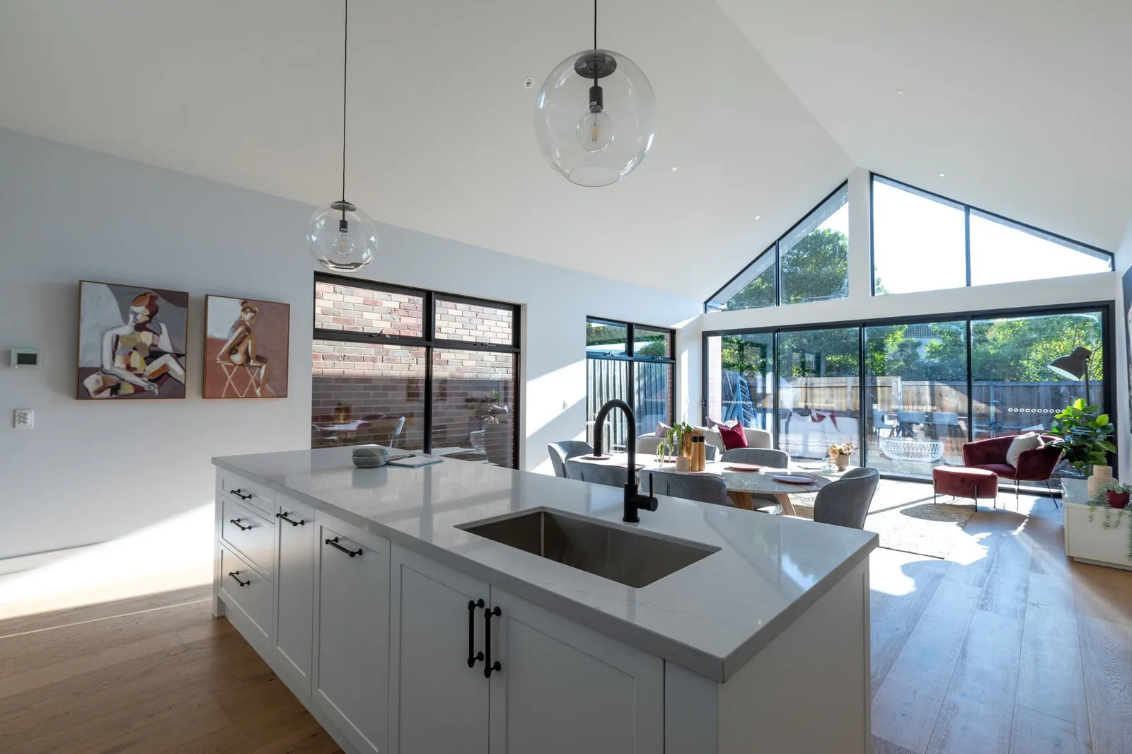 Open-plan kitchen and dining extension with gable window by Nicon Built