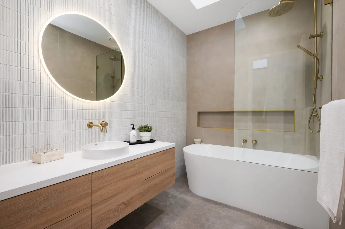 Luxury bathroom with freestanding bath and skylight — Nicon Built