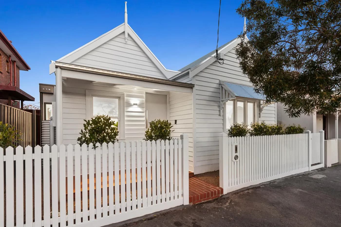 Weatherboard cottage with picket fence — Nicon Built